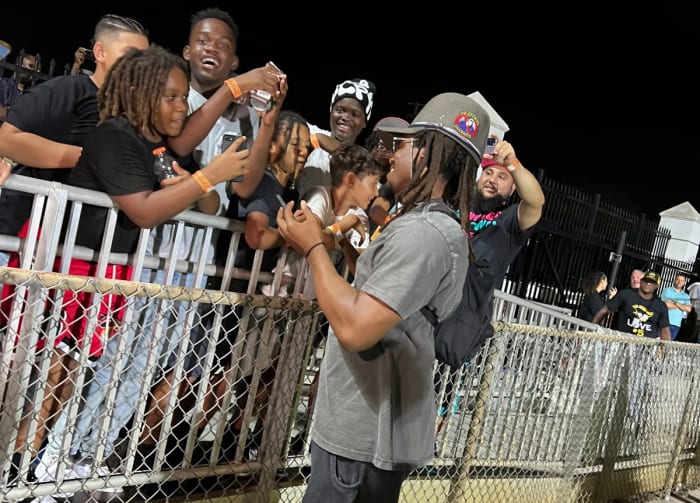 Former NFL star Cam Newton signs autographs for some of the sold out crowd on hand to see Chaminade-Madonna defeat American Heritage on Friday.
